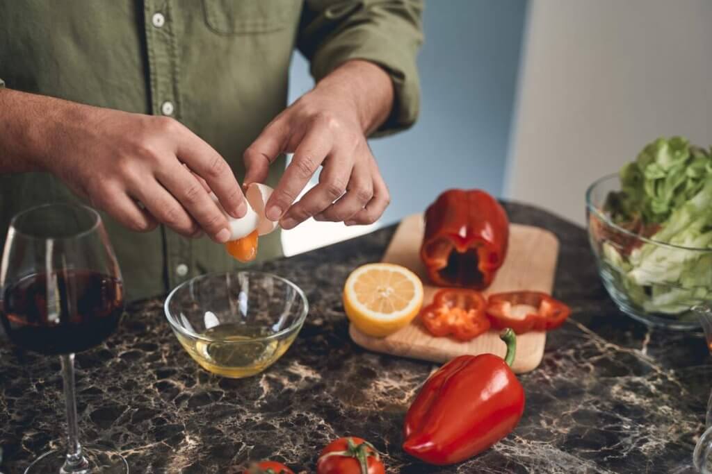 male hands cracking an egg into a bowl 2021 09 03 15 59 23 utc 1