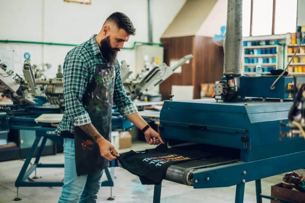 male worker using a drying oven for t shirt in a w 2022 04 15 20 31 15 utc 1